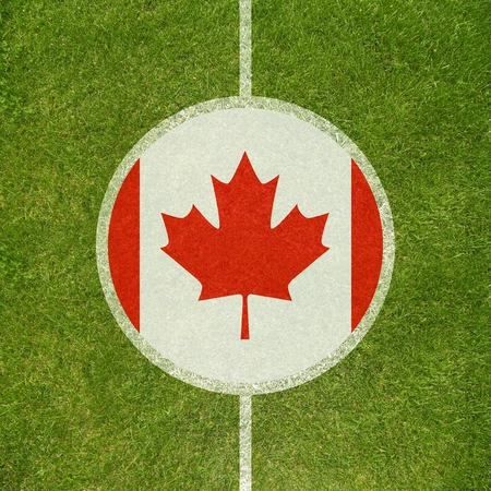 Football field center closeup with Canadian flag in circle の写真素材