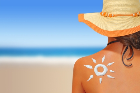 Woman with sun shaped sunscreen on her back Woman with sun shaped sunscreen on her back