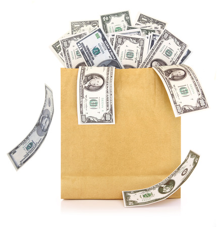 Dollar banknotes coming out of a paper bag on white backgroundの写真素材