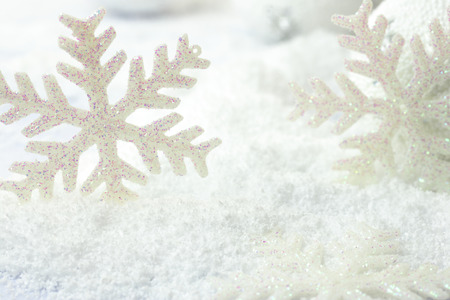 Christmas snowflakes on white snowy backgroundの写真素材