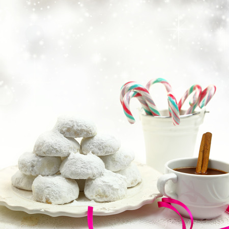 Christmas cookies with candies and coffee on white bokeh backgroundの写真素材