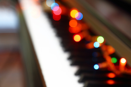 Abstract Christmas musical background with piano and lights.の写真素材