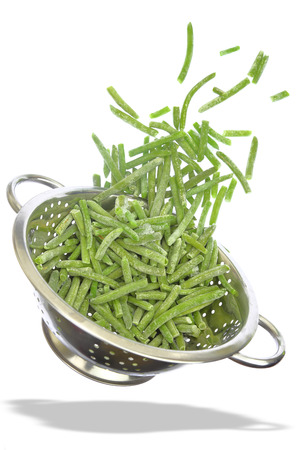 Colander with frozen green beans isolated on whiteの写真素材