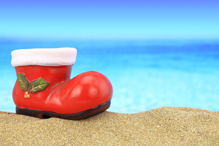 Santa claus boot ornament on sandy beach