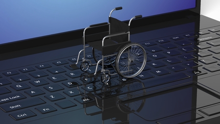 Wheelchair on black laptops keyboard, conceptualの写真素材