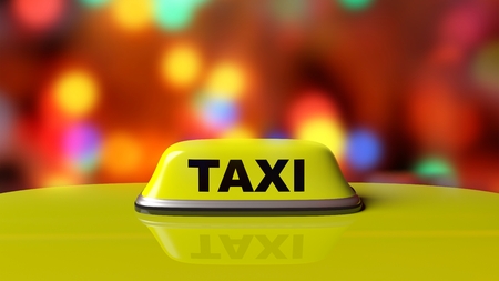 Yellow taxi car roof sign with abstract bokeh city lights backgroundの写真素材
