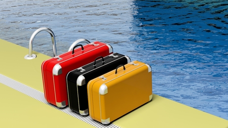Colorful suitcases beside the swimming pool crystal waterの写真素材