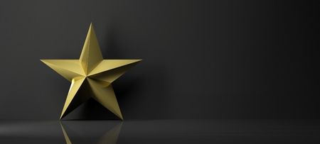 Golden star icon with reflection,isolated on black backgroundの写真素材