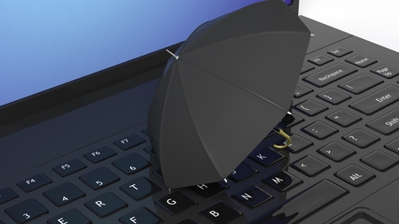 Umbrella on black laptop keyboardの写真素材