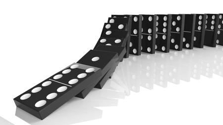 Black domino tiles falling in a row, isolated on whiteの写真素材