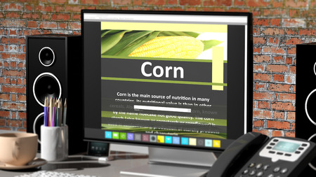 Monitor with Corn information on desktop with office objects.の写真素材