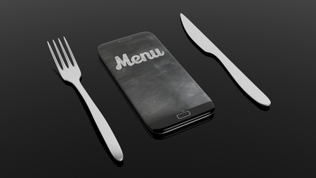 Fork, knife and smartphone with Menu written on screen, isolated on black background.の写真素材