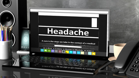 Laptop with Headache  information on screen, on desktop with office objects.の写真素材
