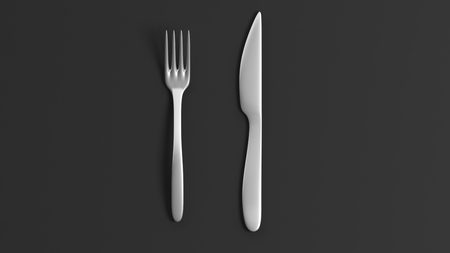 Fork and knife, isolated on black background.の写真素材