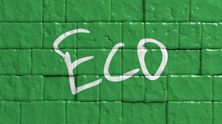 Green painted brick wall with Eco text graffitiの写真素材