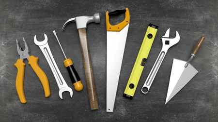 Various hand tools set on  blackboard surface