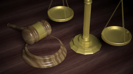 Wooden court hammer with golden scales of justice on brown tableの写真素材