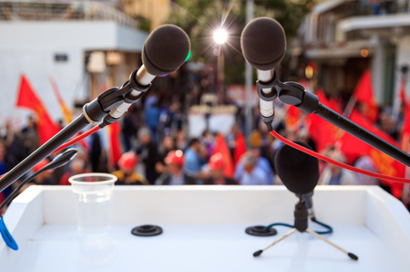 Crowd with red flags abstract background - Microphone close upの写真素材
