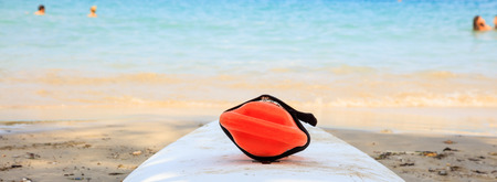 Red rescue can on a sandy beachの写真素材