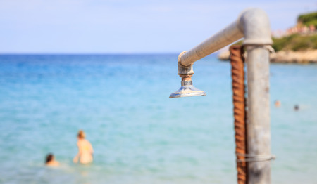 Beach shower detail on a blue sea backgroundの写真素材