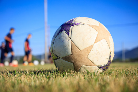 Soccer ball close up on a football field backgroundの写真素材