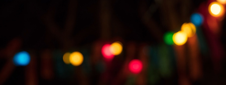 Bokeh, blurred colorful circle lights on dark background. Space for text, abstract, banner.の写真素材