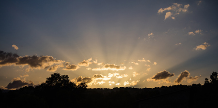 Sunrays light concept. Sunrise sunbeams through the clouds from the horizon, banner, copy space,...
