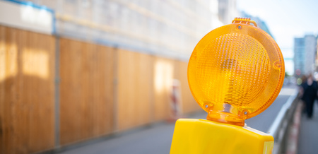 Road construction concept. Orange reflector warning light protects the drivers.の写真素材