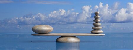 Zen stones row from large to small  in water with blue sky and peaceful landscape