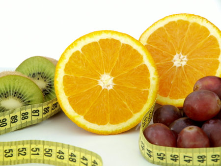 Orange, grapefruit and measuring tape on white background. Diet conceptの写真素材