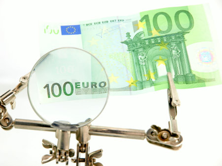Euro banknotes and magnifying glass on white background, business conceptの写真素材