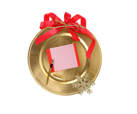 Christmas Greeting card template. Empty paper note in a gold plate isolated on whiteの写真素材