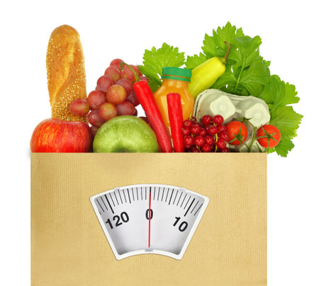 Healthy diet eating. Groceries in a paper bag with weight scale isolated on white transparent background,の写真素材