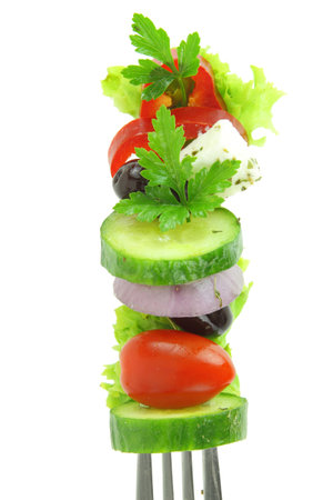 Fresh salad vegetables on a fork isolated on white transparent backgroundの写真素材