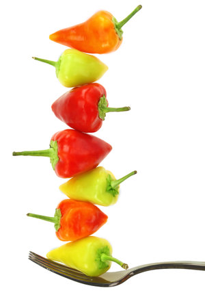 Healthy food, Fresh red and green peppers on a fork isolated on white transparent backgroundの写真素材