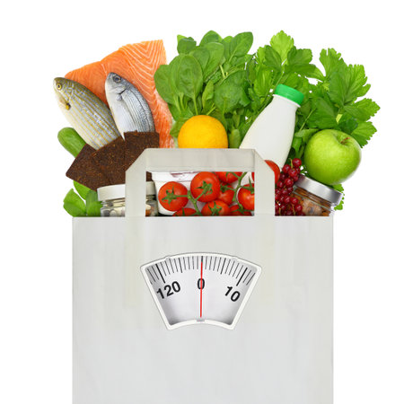 Healthy diet eating. Groceries in a paper bag with weight scale isolated on white transparent background,の写真素材