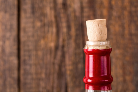 Wine bottle and cork with dark wooden backgroundの写真素材