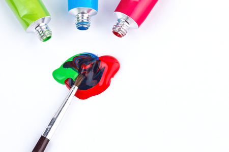 Color tempera water based paints with paintbrush mixing colorsの写真素材