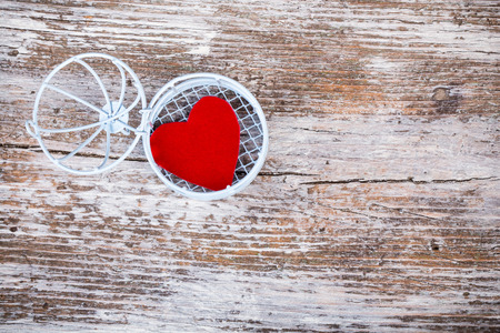 Heart in open cage with white grunge wooden backgroundの写真素材