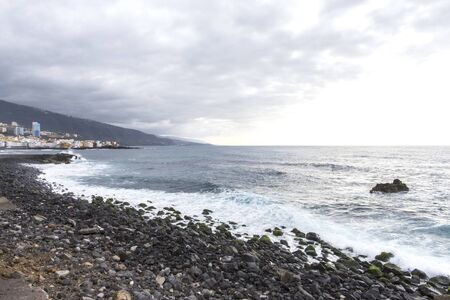 Puerto de la Cruz, Tenerife, Canary Islands - view of colorful houses, sea and volcanic-sand beach. Black beach in tenerifeの写真素材