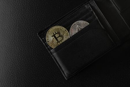 Bitcoin and ethereum cryptocurrency (crypto currency). Gold bitcoin coin with gold Bitcoin symbol on...