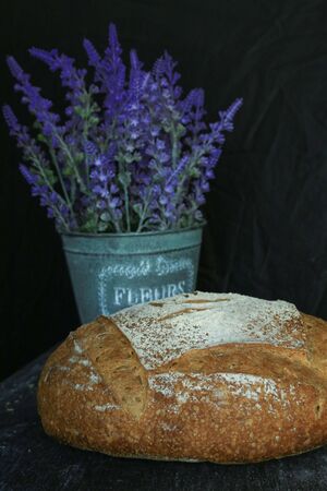Fresh homemade bread. round bread on a dark background. Mother dough bread. Homemade bread...