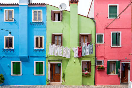 Burano, Venice, Italy - May 21, 2019: Colorful painted residential houses in Burano island, Venice, Italy. Burano street with ï¿½olorful facade building. Colorful architecture in Burano island.のeditorial素材