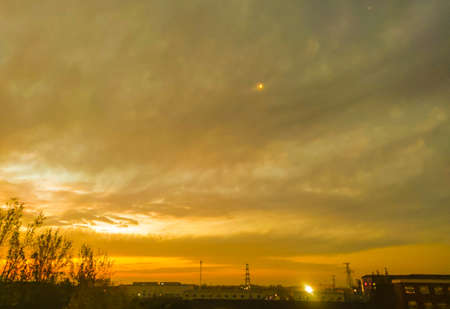 a cloudy sunset landscape with sunの写真素材