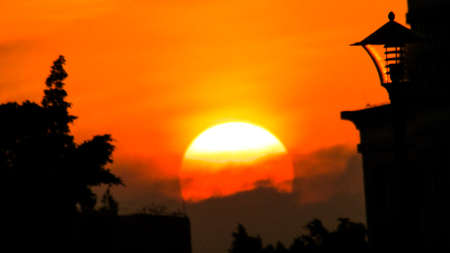 a cloudy sunset landscape with sunの写真素材