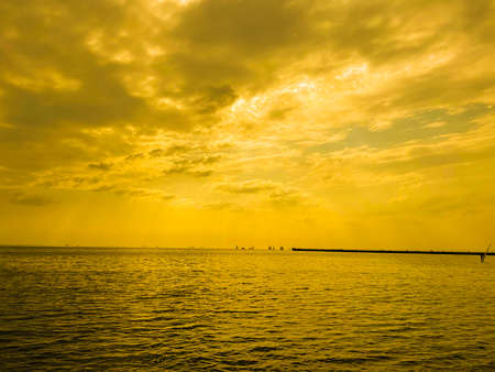 a cloudy sunset landscape with sunの写真素材