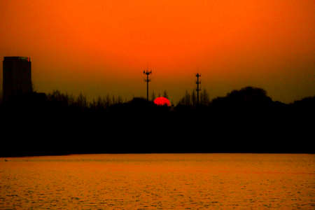 a cloudy sunset landscape with sunの写真素材