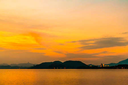 a cloudy sunset landscape with sunの写真素材