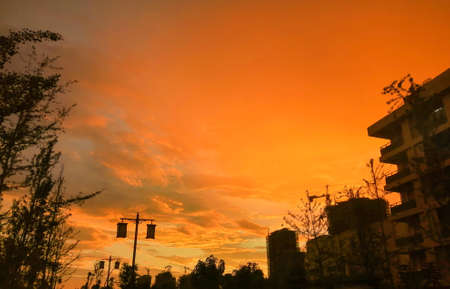 beautiful cloudy sunset landscape with sunの写真素材