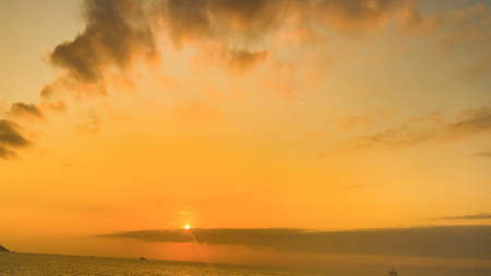 Beautiful cloudy sunset landscape with sunの写真素材